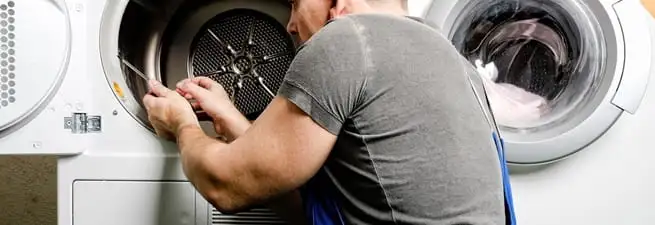 Dryer repair technician fixing a clothes dryer drum in Albuquerque, NM