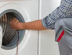 Dryer repair technician diagnosing and servicing a clothes dryer in Albuquerque, NM