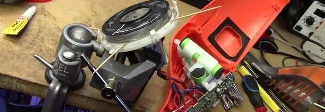 Vacuum cleaner repair parts and tools on a workbench in Albuquerque, NM