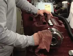 Vacuum repair technician cleaning and servicing a vacuum motor in Albuquerque, NM