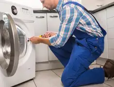 Washing machine repair technician servicing a front-load washer in Albuquerque, NM